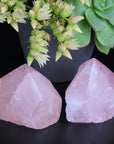 Image shows two top polished rose quartz generators, a beautiful soft pink in colour.