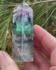 Video shows a polished fluorite generator. Purple, green and clear in colour.
