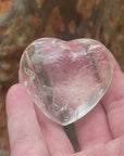 Video shows an A grade polished clear quartz heart with high clarity and lots of inclusions.