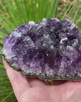 Video shows an amethyst cluster, deep purple in colour with long crystals and very little matrix.