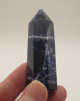 Image shows a polished Sodalite generator, deep blue in colour with white marble like inclusions.