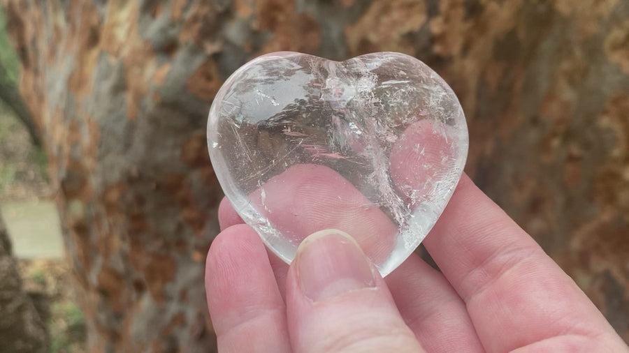 Video shows an A grade polished clear quartz heart with high clarity and inclusions. W 6.5cm