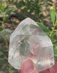 Video shows a large polished clear quartz generator with an intergrown crystal point inside the generator. H 10cm W 6cm D 4cm 