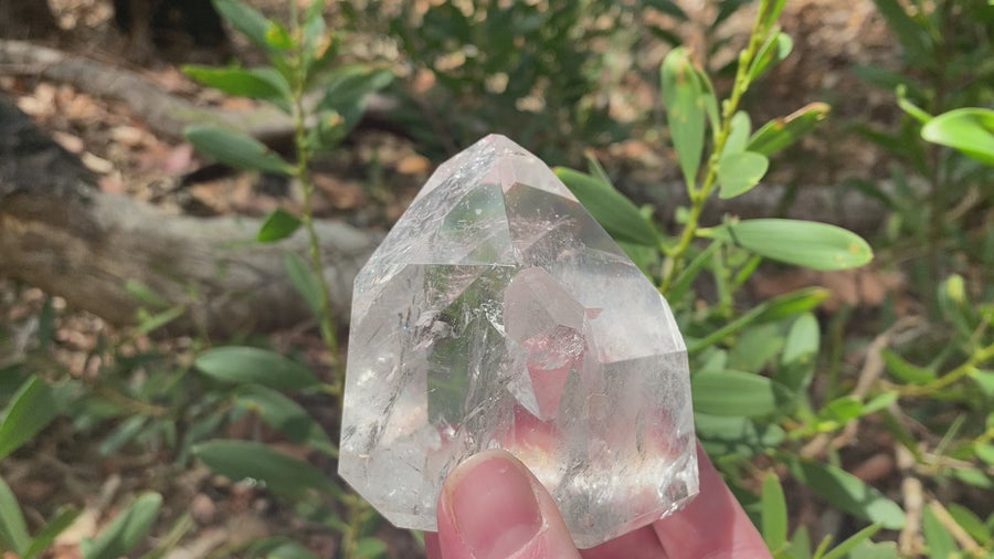 Video shows a large polished clear quartz generator with an intergrown crystal point inside the generator. H 10cm W 6cm D 4cm 