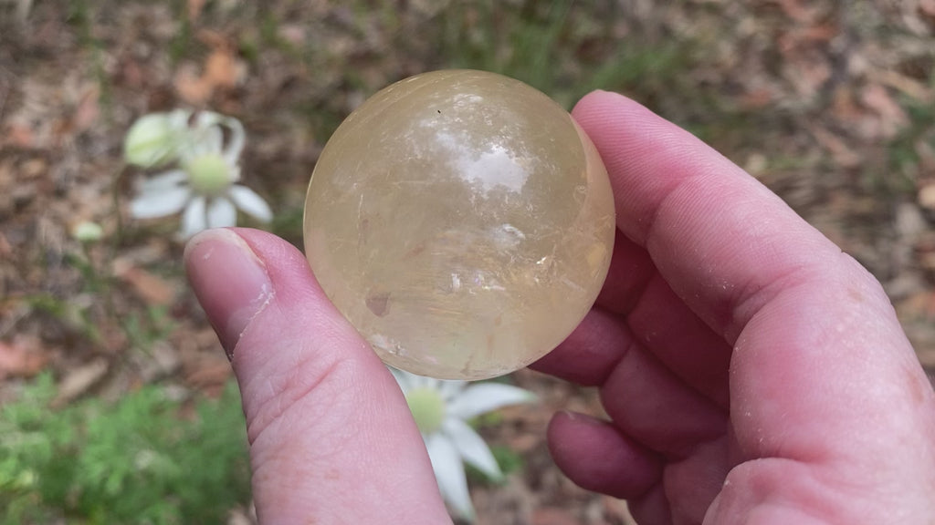 Video shows a polished golden calcite sphere Diameter 4cm. 