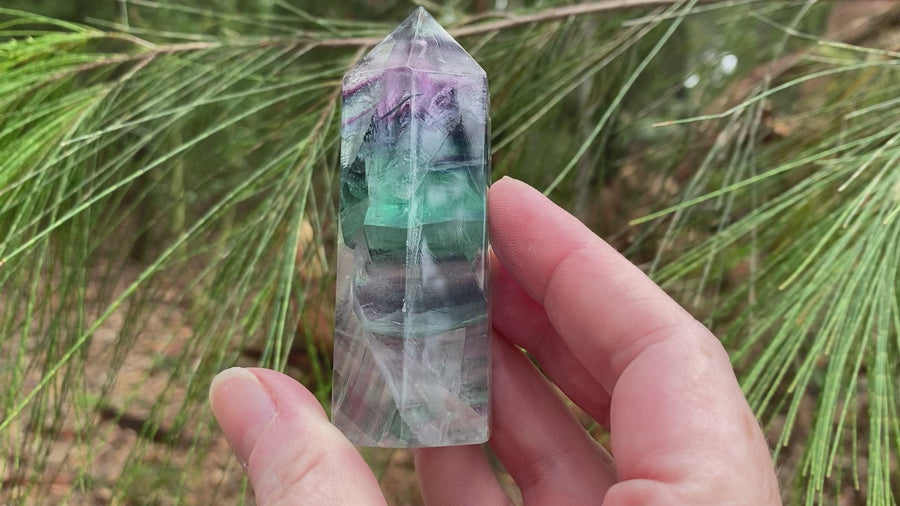 Video shows a polished fluorite generator. Purple, green and clear in colour. 