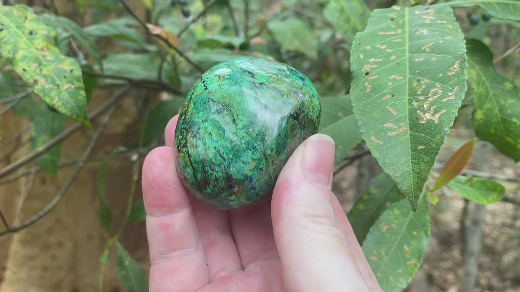 Video shows a polished piece of azurite and malachite with deep hues of blue and green in a marbled pattern. 