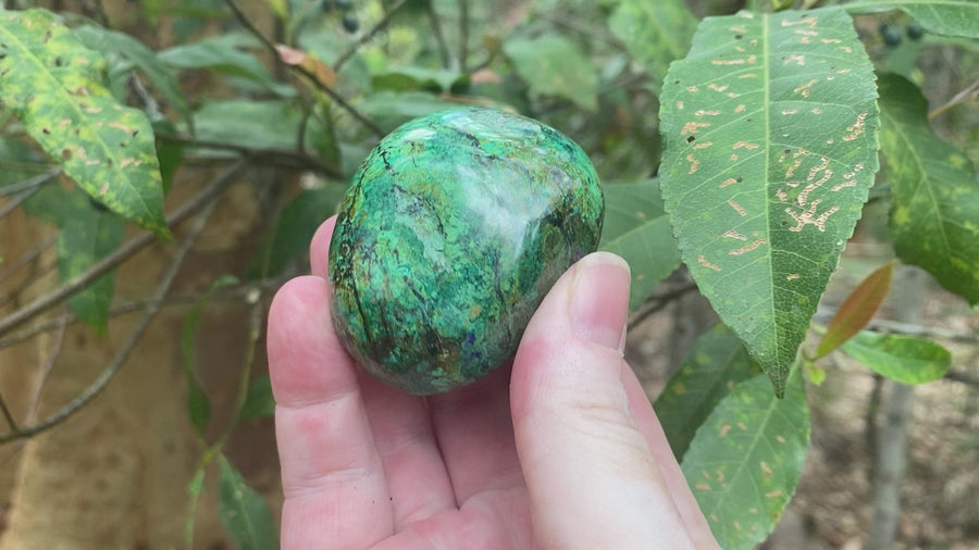 Video shows a polished piece of azurite and malachite with deep hues of blue and green in a marbled pattern. 