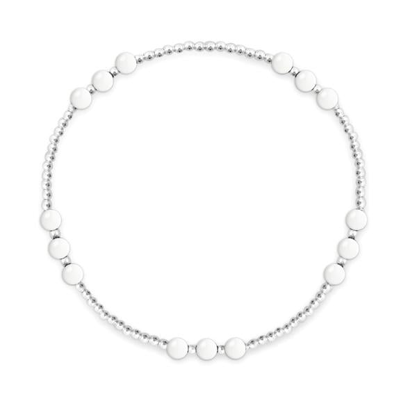 Picture shows a sterling silver beaded bracelet with white agate beads in groups of three at five different parts of the bracelet. 