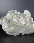 Image shows a specimen piece of an apophyllite cluster with desert rose (gypsum) inclusions. 