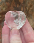 Video of a polished clear quartz heart with a small rainbow inclusion.