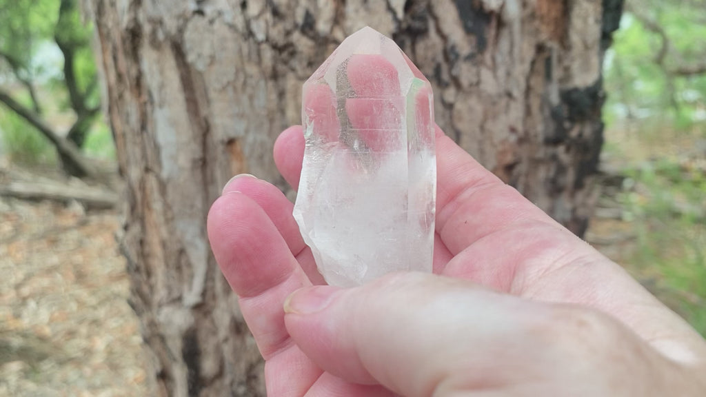 Video shows a natural clear quartz point with a thumb notch. H 8cm W 5.5cm D 4cm