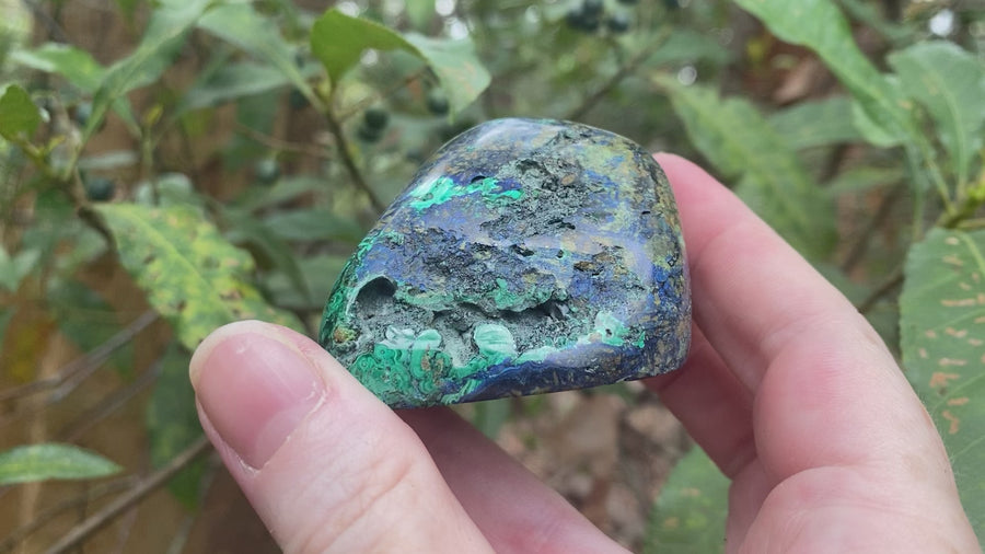 Video shows a polished piece of azurite and malachite with deep hues of blue and green in a marbled pattern. 