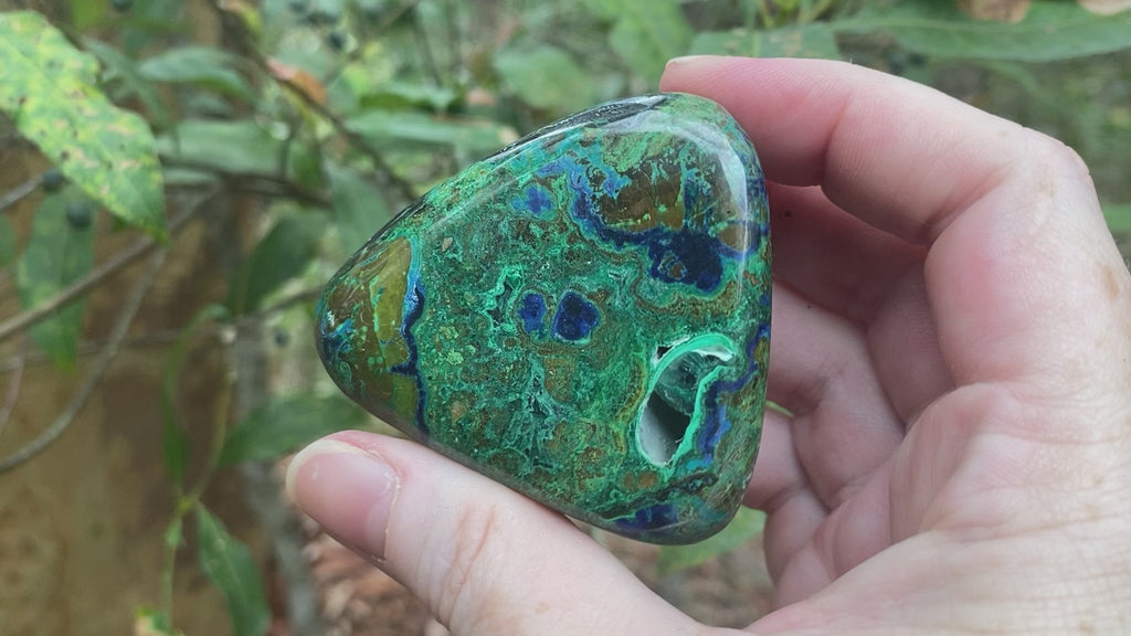 Video shows a polished piece of azurite and malachite with deep hues of blue and green in a marbled pattern. 