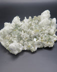 Image shows a specimen piece of an apophyllite cluster with desert rose (gypsum) inclusions. 